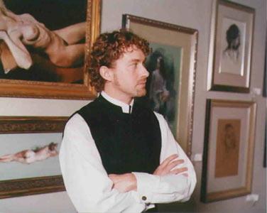 Miles Mathis pictured in front of his art